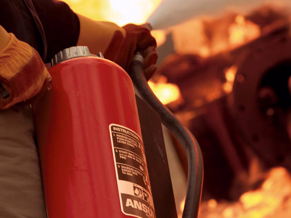 A fire extignuisher being used to put out fire