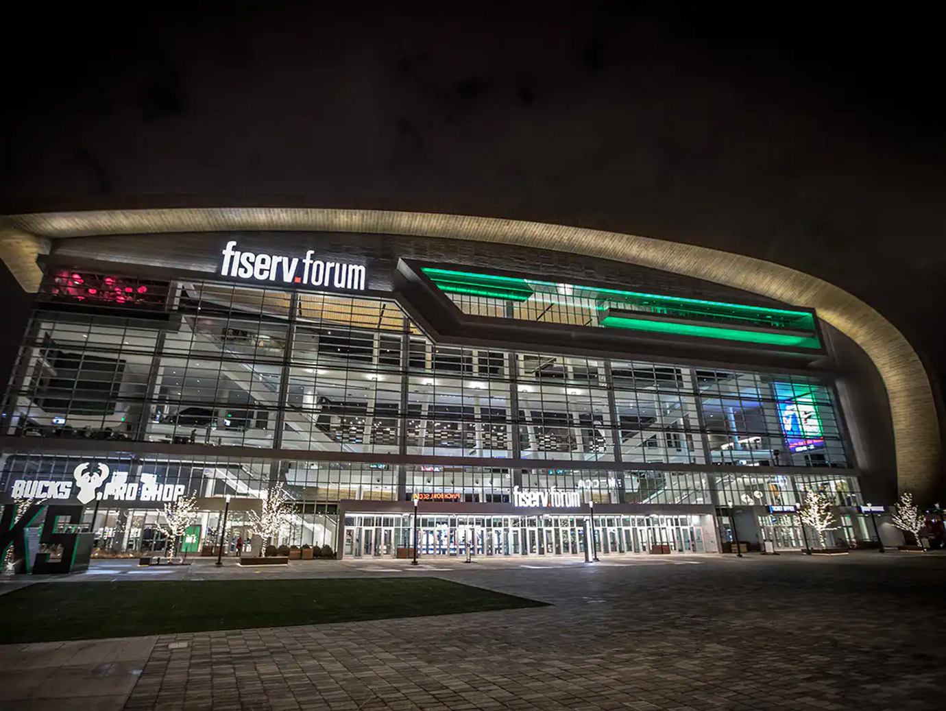 Exterior of the Fiserv Forum lit up during night-time