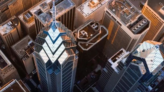 Aerial view of an urban skyline, with the One Liberty Place building in view