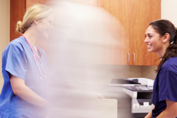 Doctors, patients and nurses walking along a hospital passage
