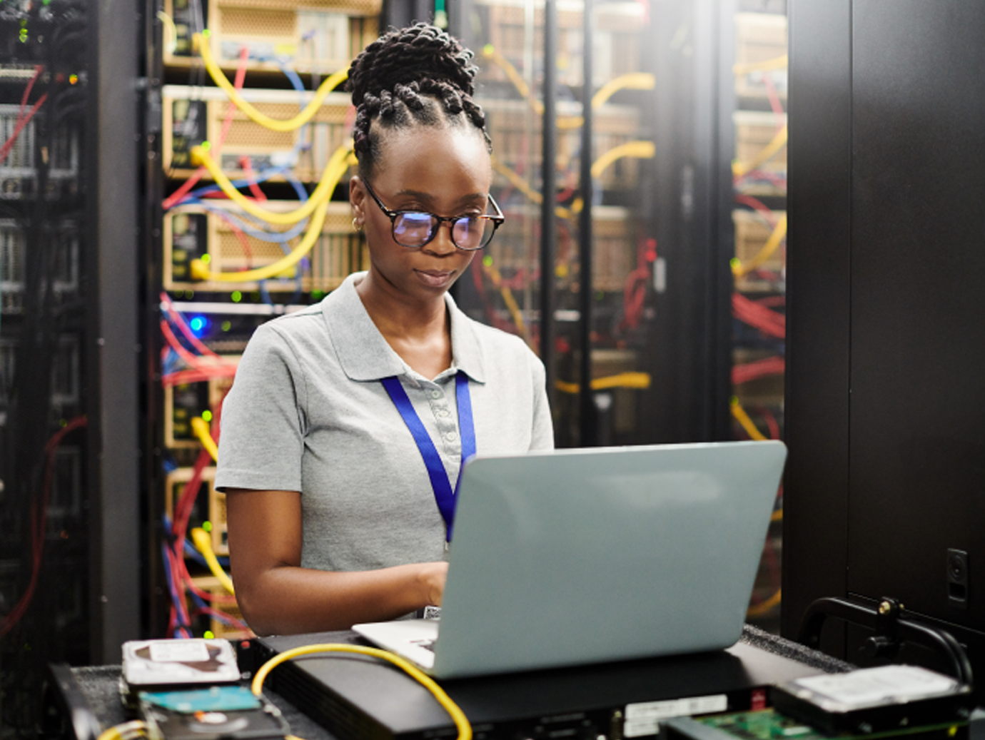 A woman with goggles working on the laptop