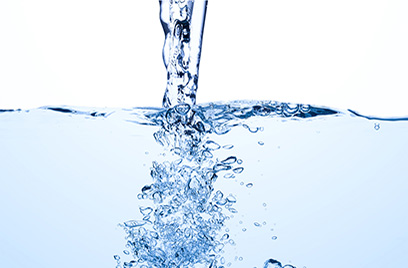 Light blue tinted water being poured