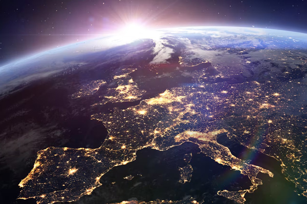 The sun rising over the earth as seen from space