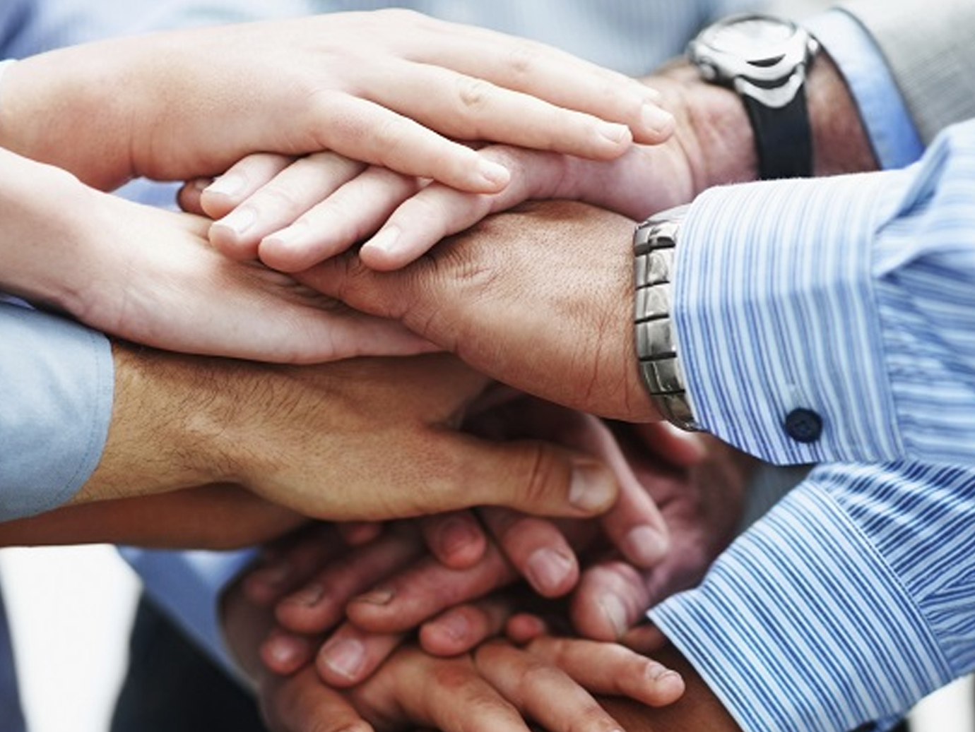 Close up shot of people with their hands stacked together