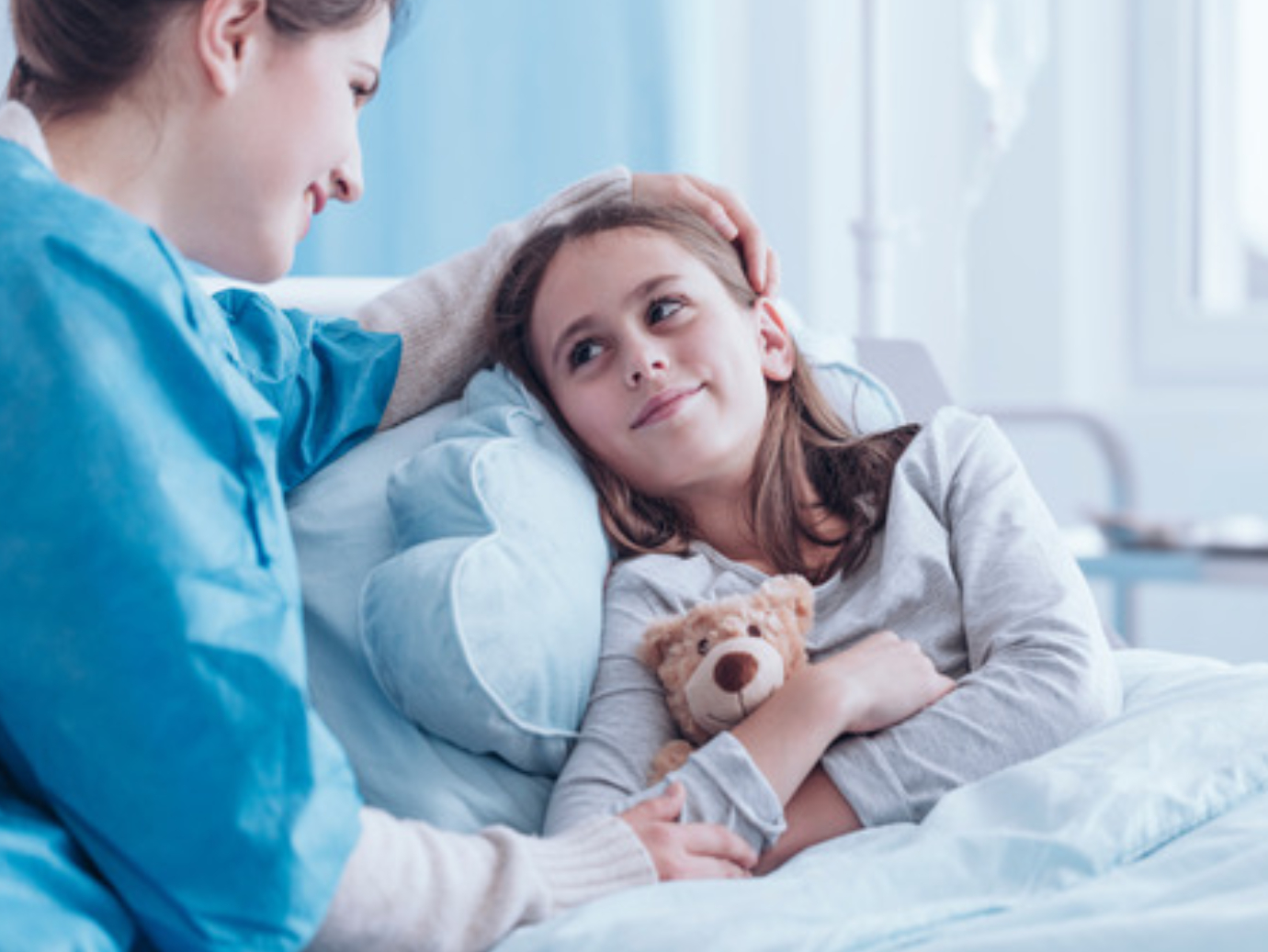 Nurse taking care of girl in hospital