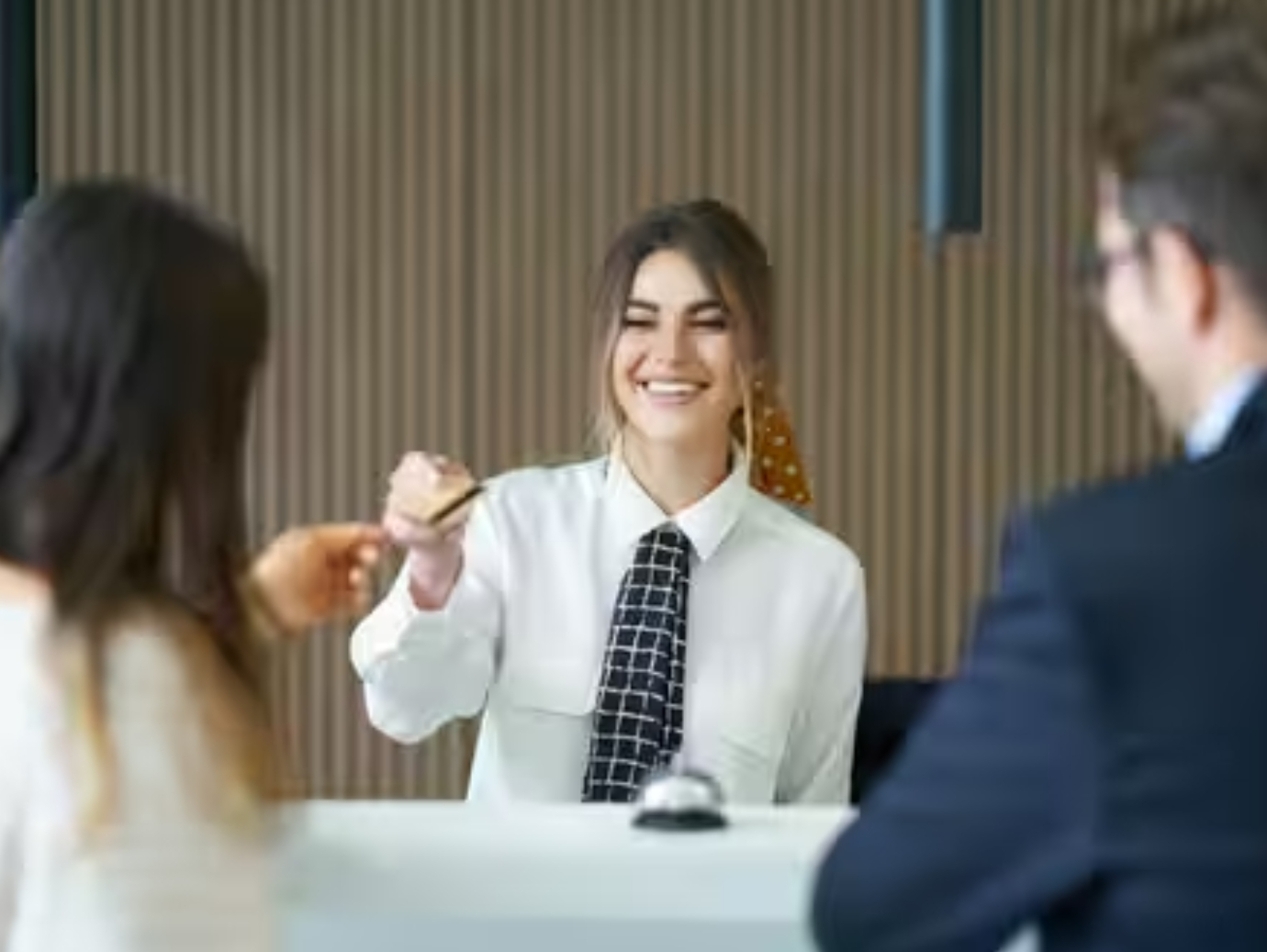 Receptionist working in a hotel giving card to guest