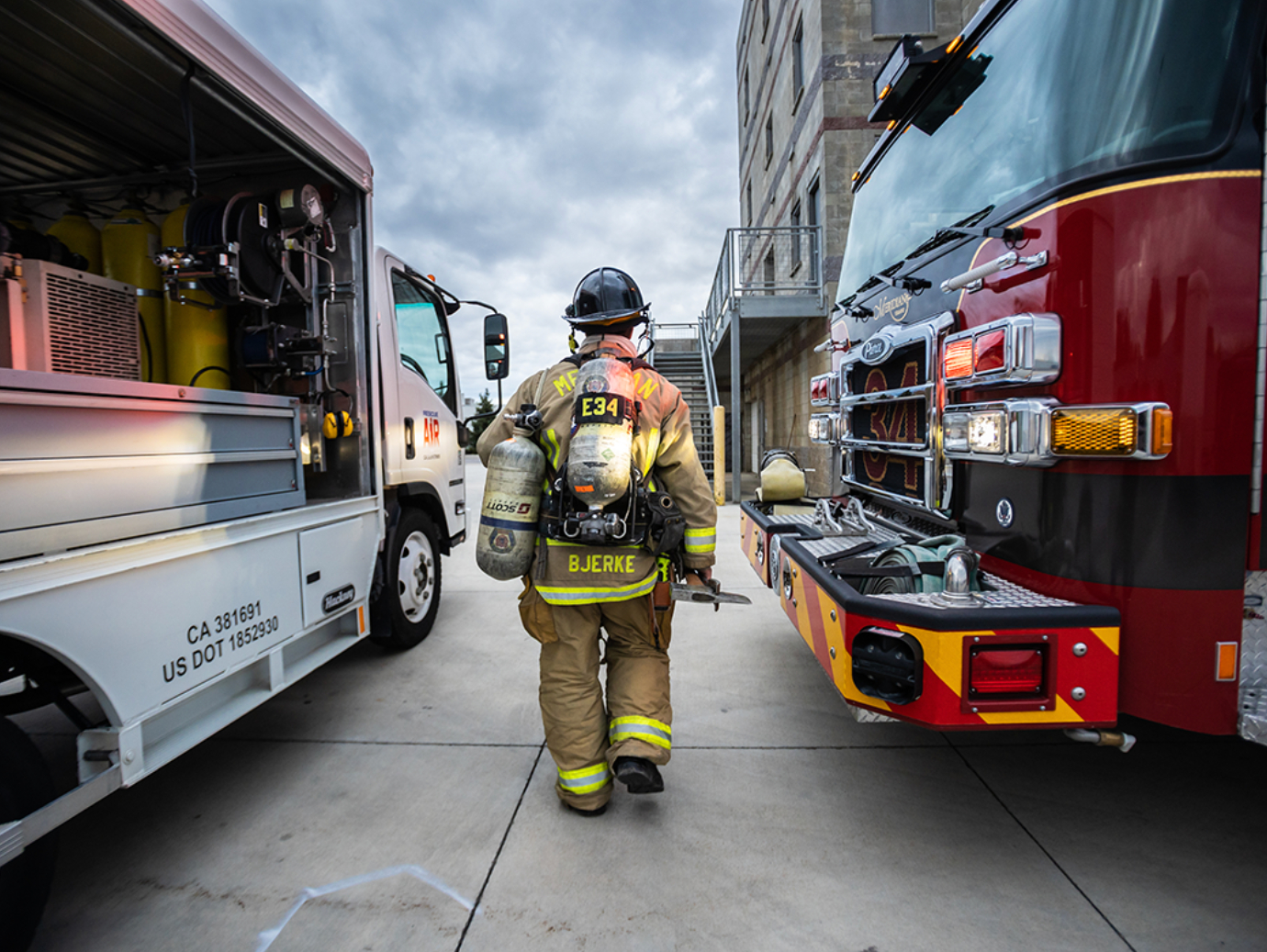 firefighter walking between firetrucks