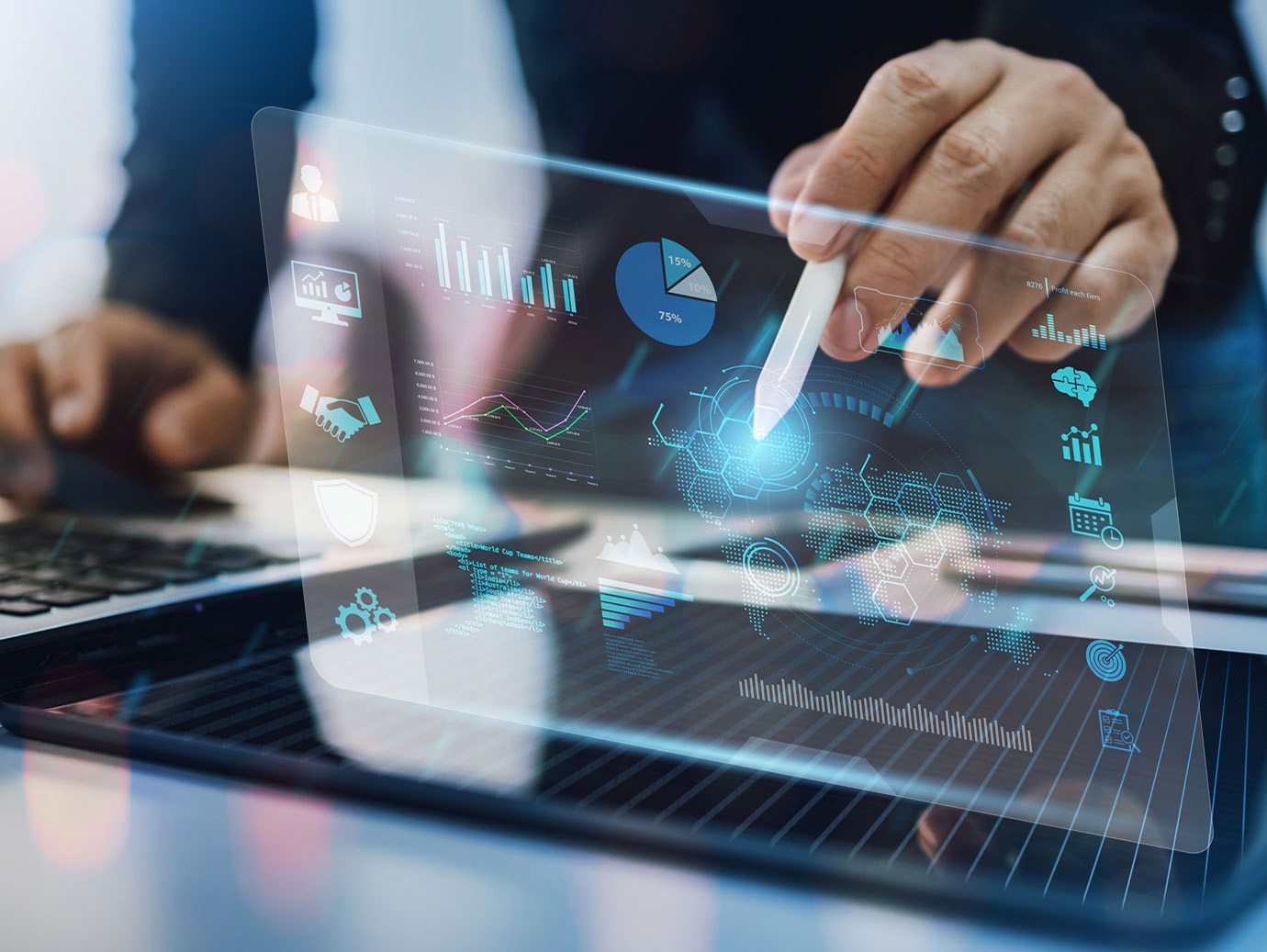 Close-up of a man pointing a stylus at holographs showing various data