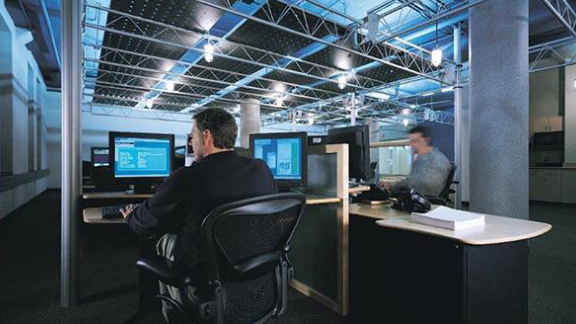 Two men working on computers in an office