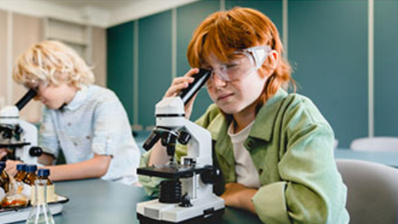 A child looking through a microscope