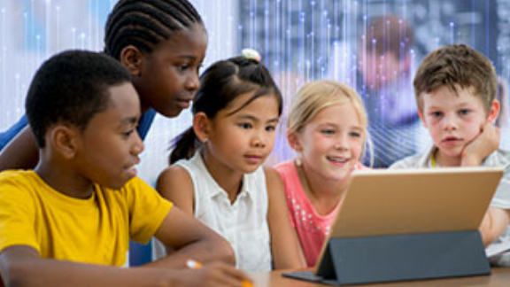 A group of children looking at a tablet with modern graphics