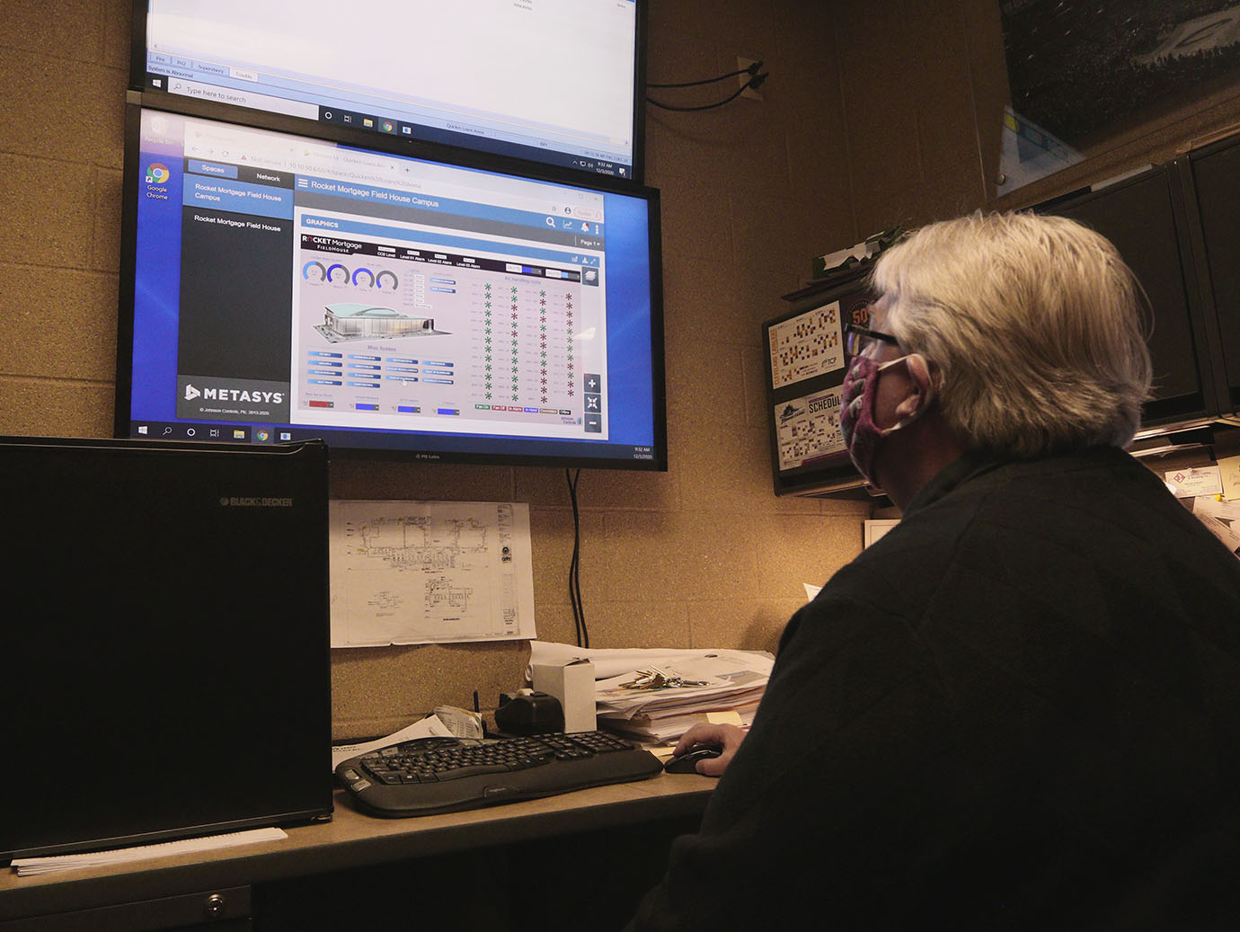 Man in face mask working on a computer