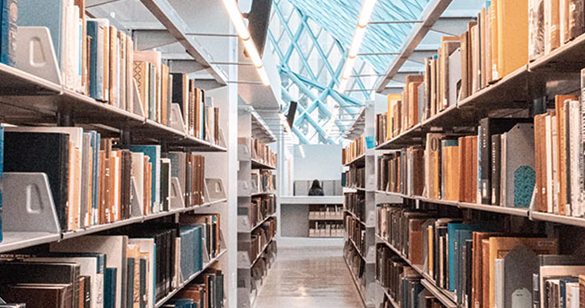 An aisle between bookshelves in a library
