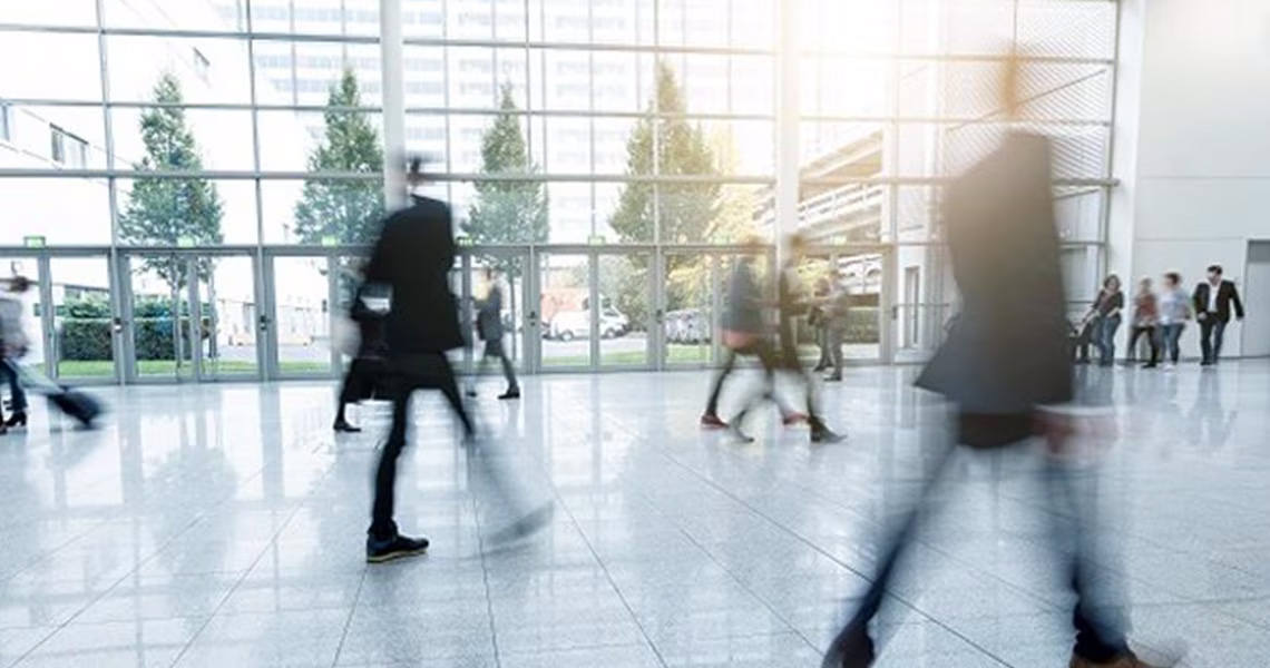 A blurred shot of people walking in an office