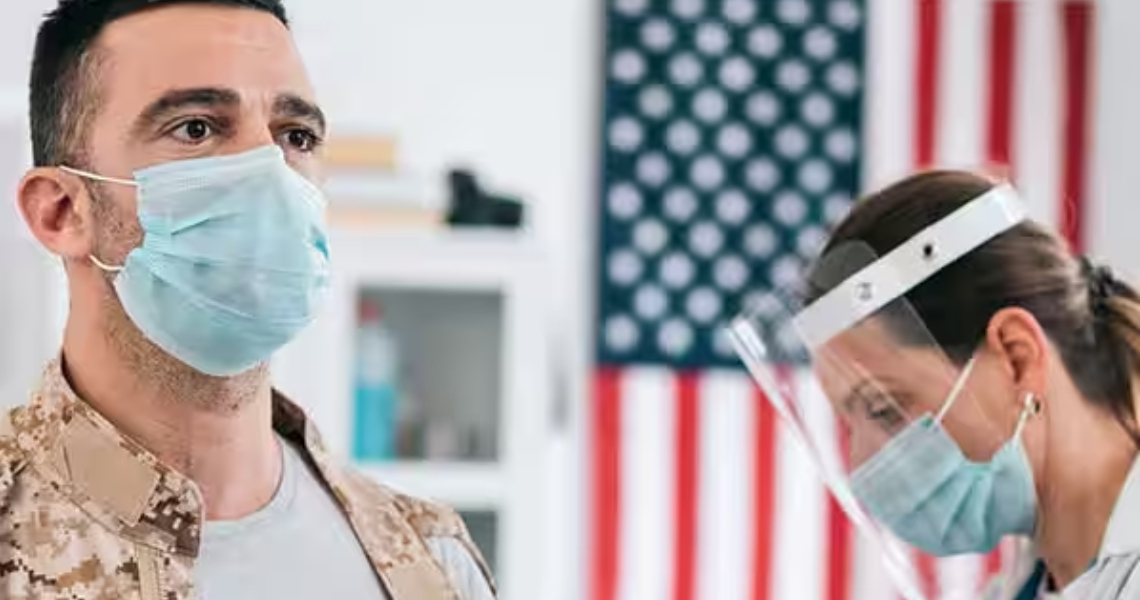 A man and a healthcare professional in a face mask