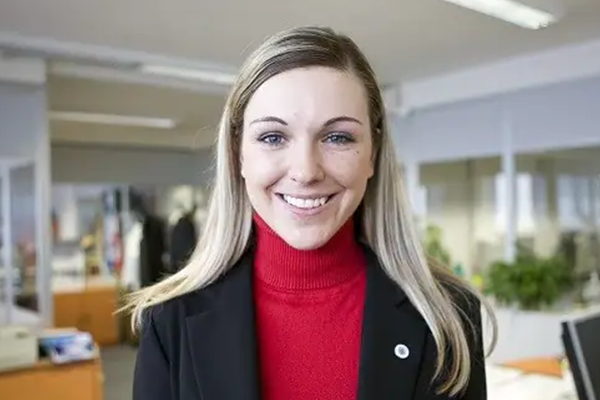 A female employee smiling at the camera in office