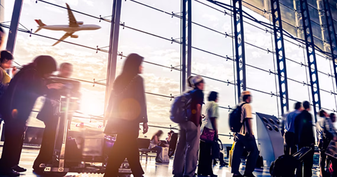 Passengers walking along a passage in an airport terminal