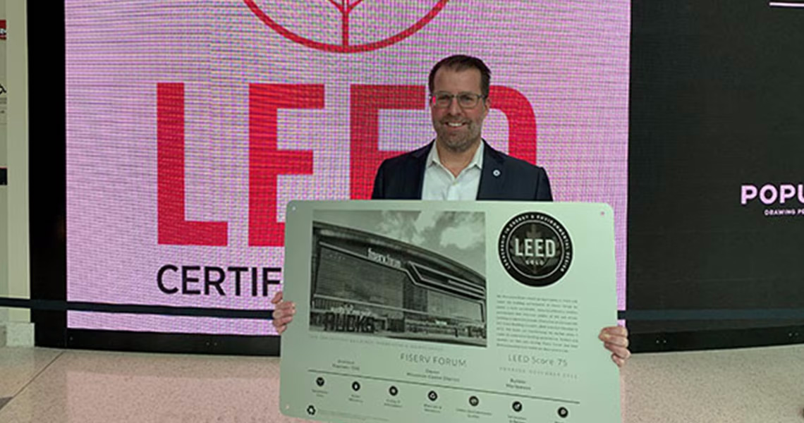 Nate Manning, President, North America Building Solutions, Johnson Controls posing with the LEED® Gold Certificate