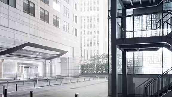 Grayscale image of the parking lot stairwell outside a commercial building