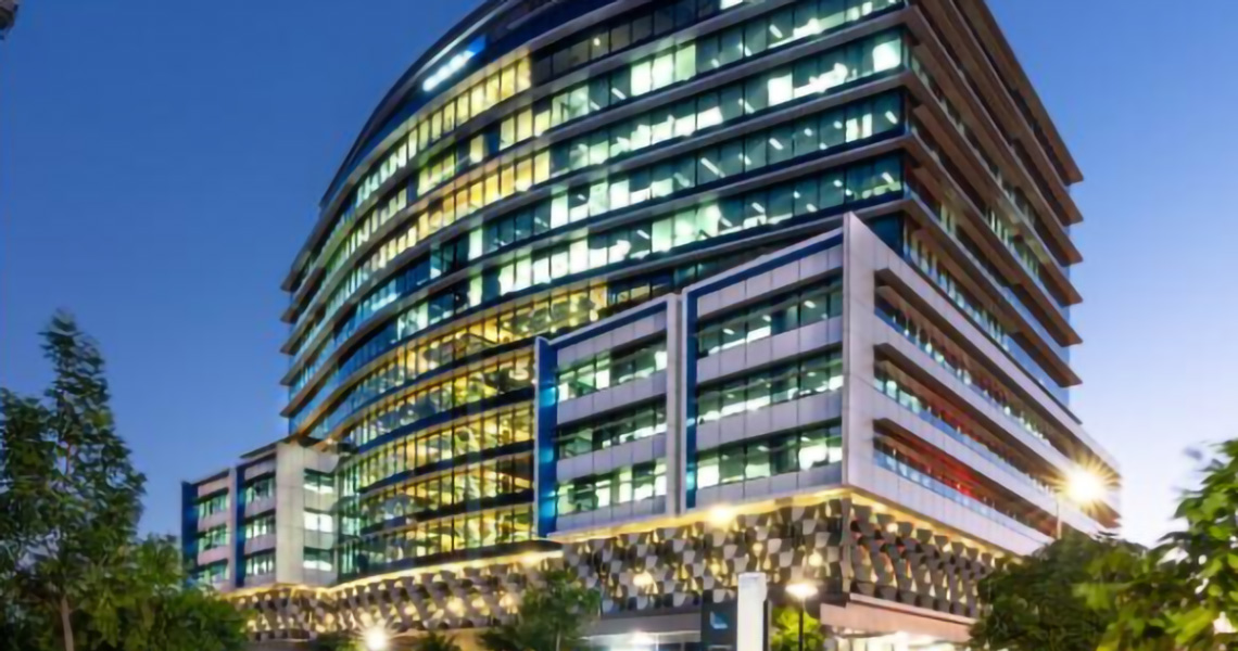 100 Skyring Terrace building lit up at dusk