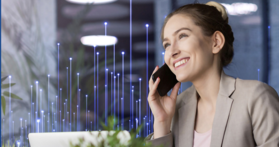 A businesswoman smiling while talking on her mobile