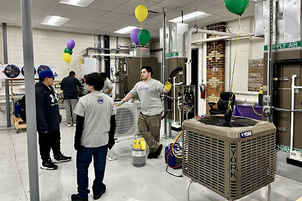 Waukegan High School students show off some of the equipment in the HVAC lab