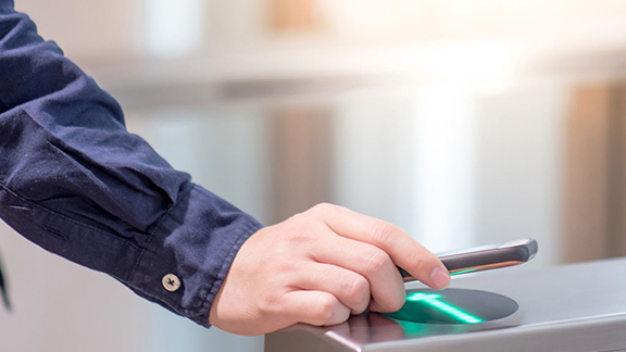 A phone being scanned by access control hardware