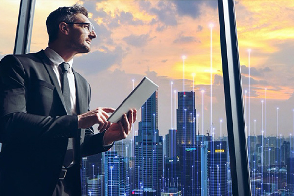 Man leaning against a window while working on a tab