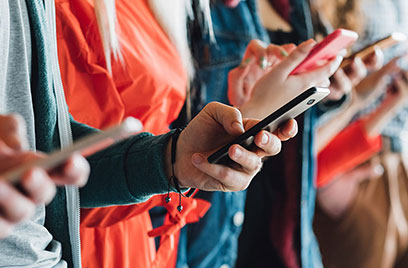 group of people checking mobiles
