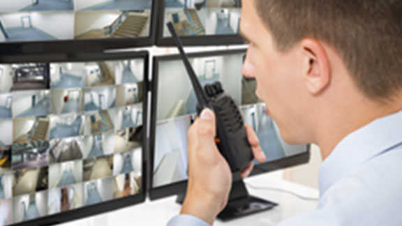 security officer speaking handheld transreceiver