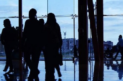 Silhouette of people walking inside a building