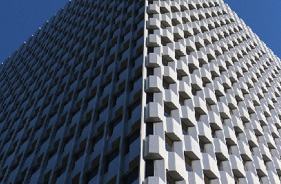 A white, modern building against the sky