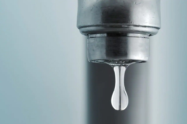 Close-up of a drop of water falling out of a tap