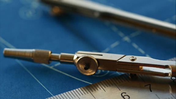 A metal ruler scale and a compass on a blue map