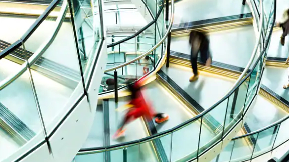motion-blur shot of people walking on a staircase