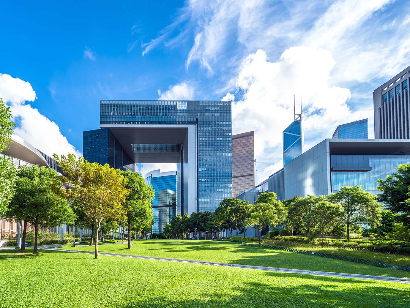 Corporate buildings behind a lawn and tress
