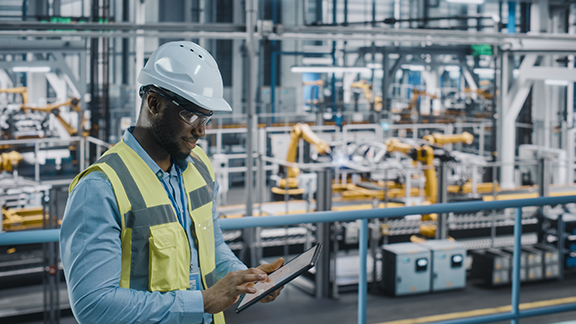 A maintenance worker scrolling on a tablet