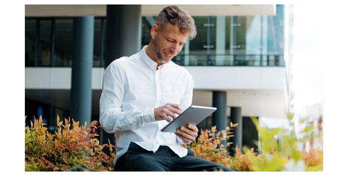 Man sitting and using his tablet