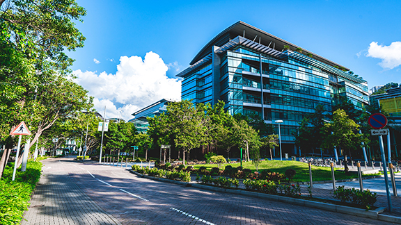 A corporate building surrounded by greenery