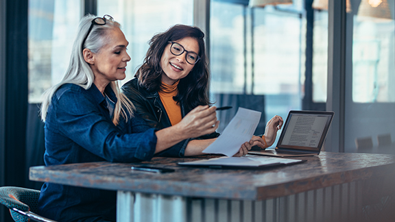Two women discussing a document at work