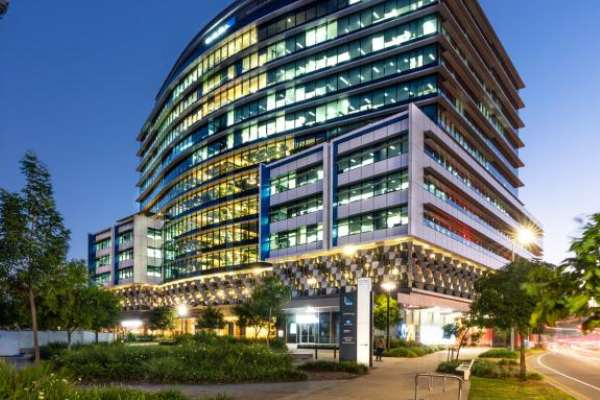 100 Skyring Terrace building lit up at dusk