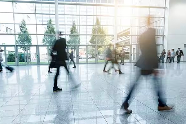 A blurred shot of people walking in an office